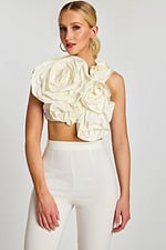 Front view of off-white crop top with oversized sculpted floral design and high-waisted pants