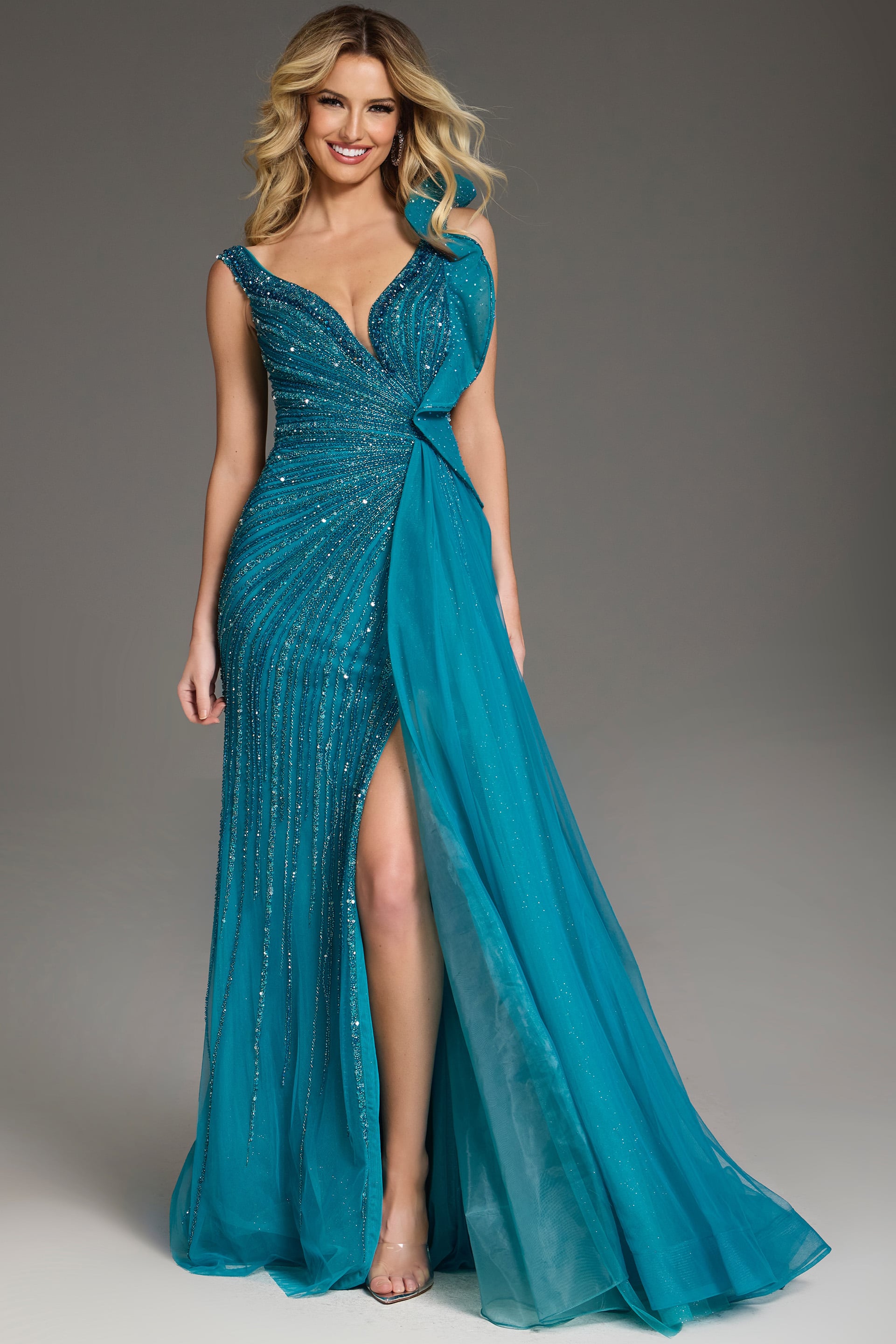 44846-beaded Model wearing Jovani 44846 blue beaded gown with asymmetrical shoulder and high slit.
