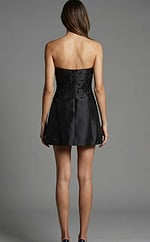 Back view of strapless short dress with embellished bodice and smooth zip back closure