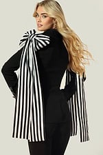Fashion-forward black blazer and pants with dramatic bow shoulders