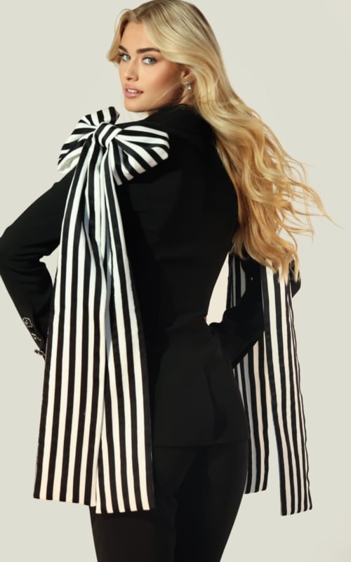 Fashion-forward black blazer and pants with dramatic bow shoulders