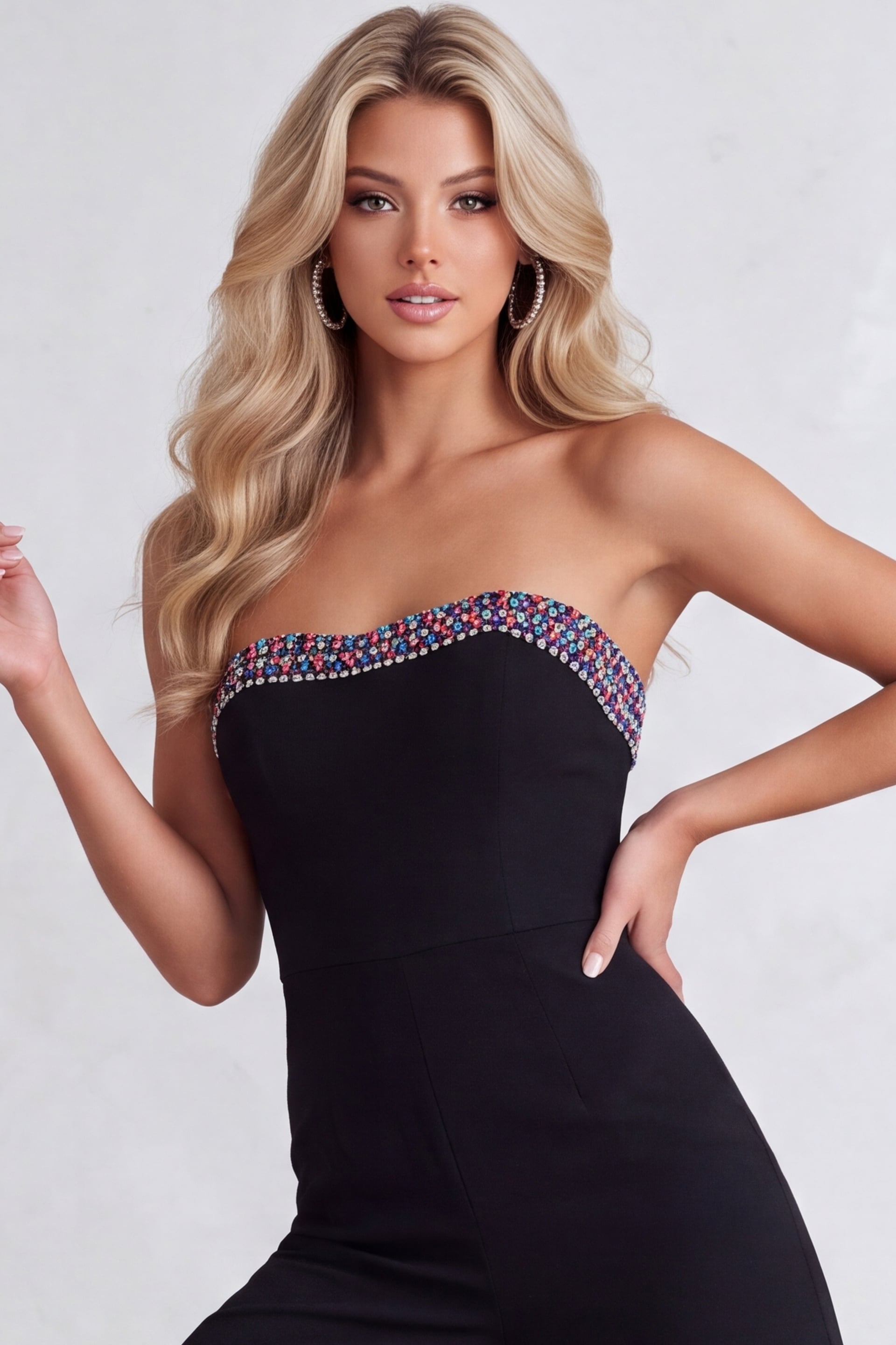 Black strapless jumpsuit with jeweled sweetheart neckline.