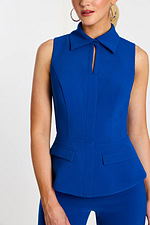 Close-up of collared neckline with subtle keyhole detail and flap pockets at the waist
