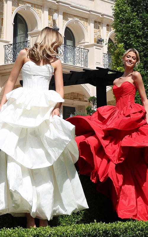 strapless layered ruffle ball gown - two girls front, white red dresses holding skirts