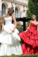 strapless layered ruffle ball gown - two girls front, hair covering face smiling fanning skirt