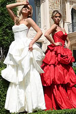 strapless layered ruffle ball gown - two girls front, contrasting poses, one smiling, one serious