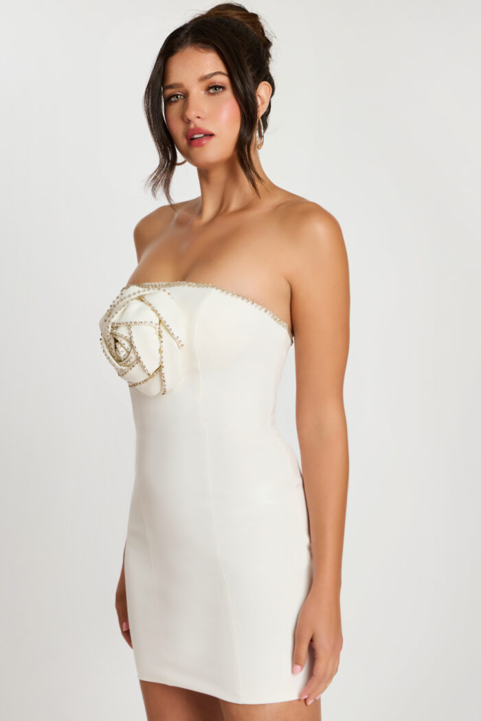 Side view of fitted off-white strapless dress with rose bodice detail