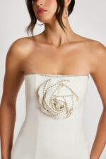 Close-up of 3D beaded rose detail on off-white mini dress