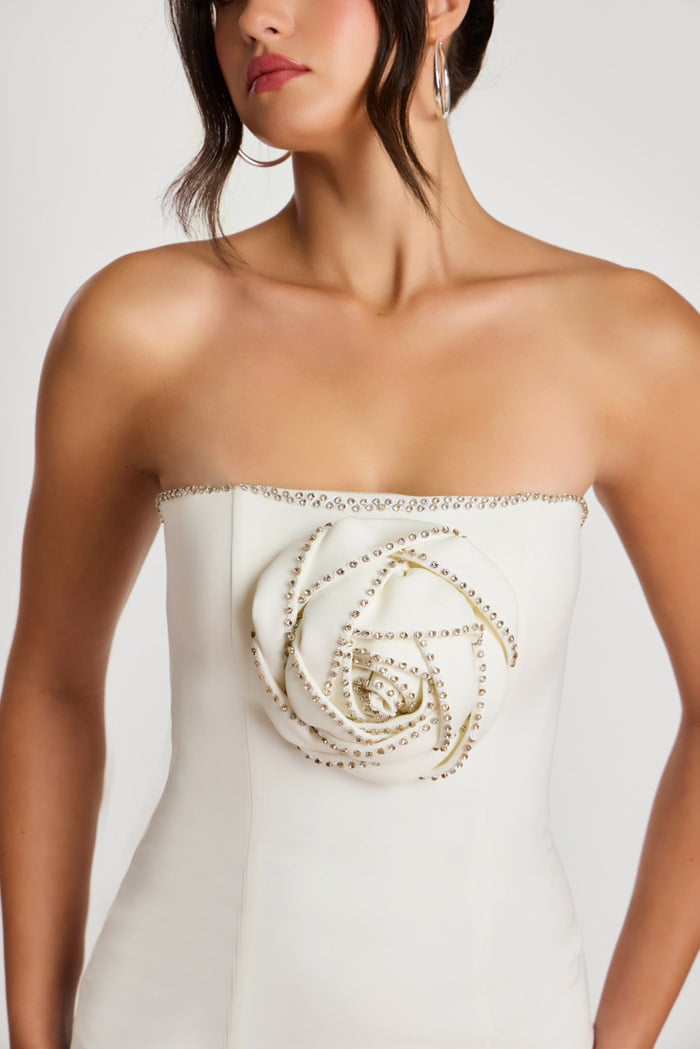 Close-up of 3D beaded rose detail on off-white mini dress