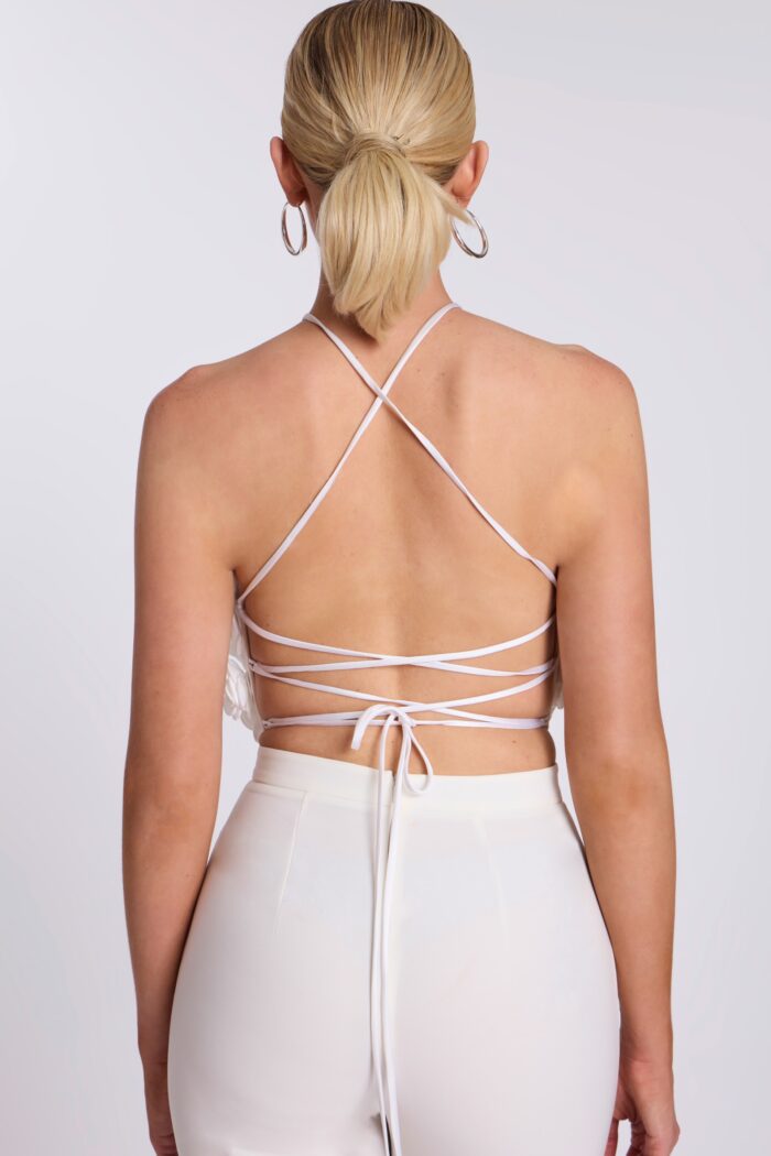 Back view of lace-up strappy halter crop top with open back
