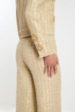 Close-up of sleeve cuff detailing with pearl and bead buttons