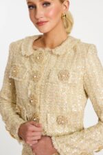 Detailed view of sequin tweed texture and floral pearl buttons