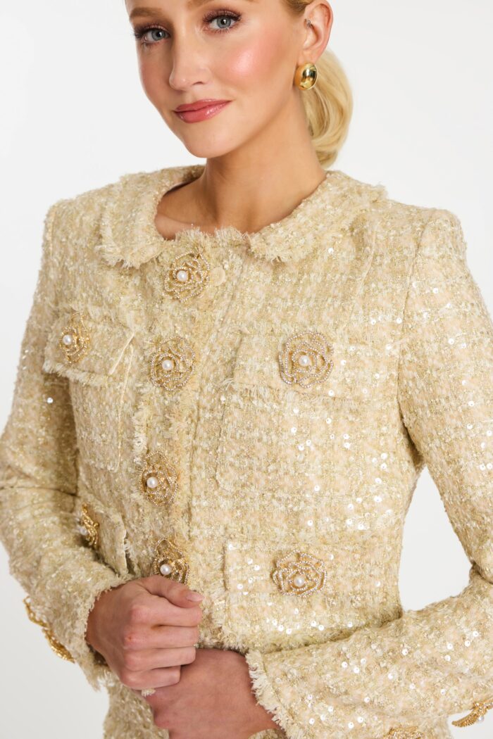 Detailed view of sequin tweed texture and floral pearl buttons