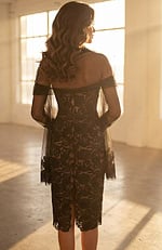 Back view of strapless lace dress with sheer overlay and center slit