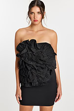 Close-up of large layered ruffles on strapless black party dress