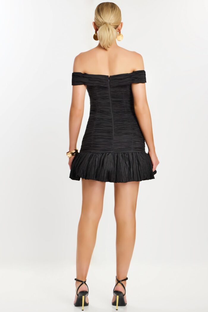 Back view of off-the-shoulder black mini dress with ruched texture
