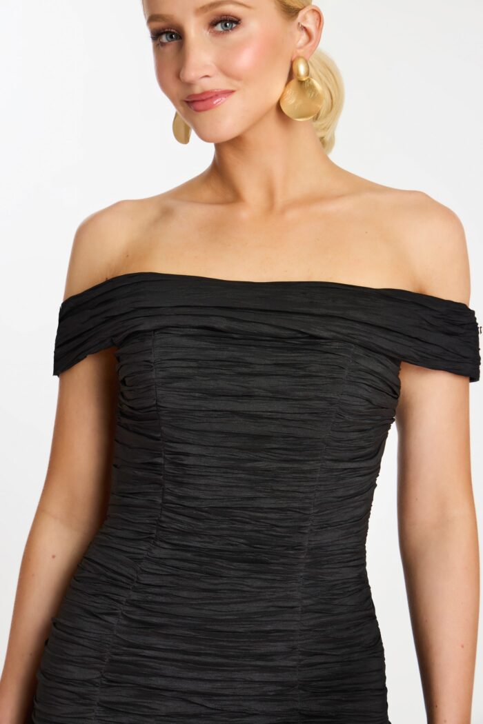 Close-up of crinkle ruched fabric on fitted off-shoulder mini dress