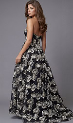 Back view of a strapless formal gown with an open back and flowing floral skirt