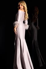 Off shoulder satin gown with feather trimmed sleeves and side ruffle detail