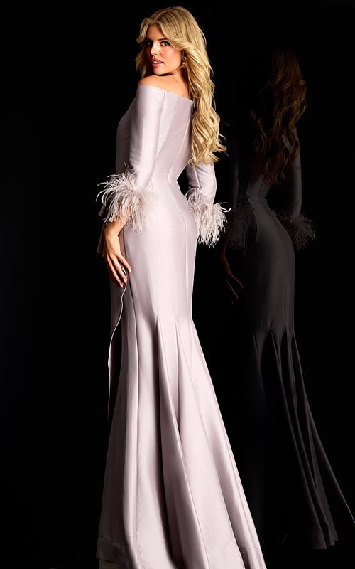 Off shoulder satin gown with feather trimmed sleeves and side ruffle detail