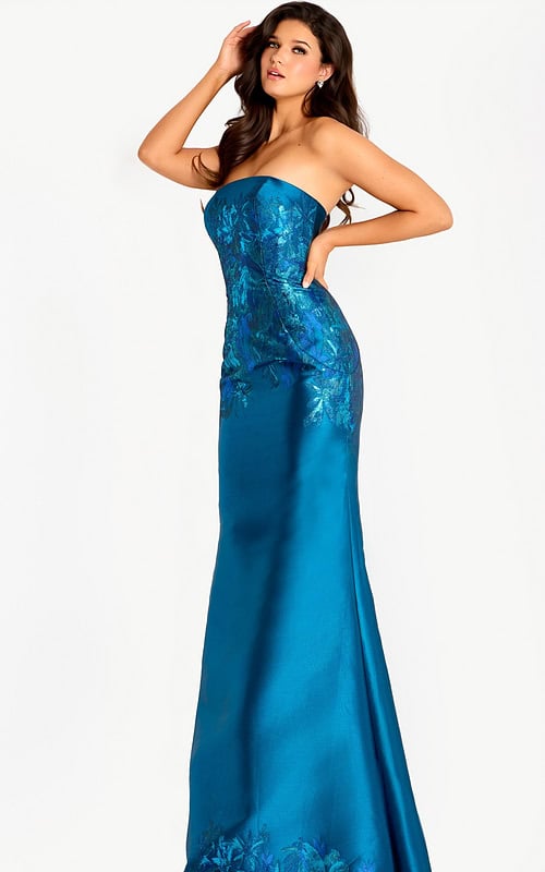 Strapless teal gown with a metallic floral jacquard bodice and smooth satin skirt, paired with dramatic off-shoulder draped sleeves for a refined and luxurious look.