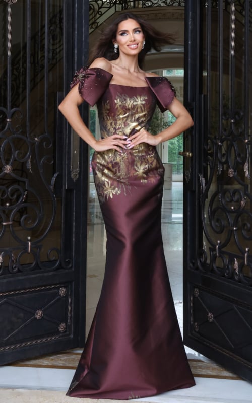 Burgundy off-the-shoulder mermaid gown with metallic gold floral print and puff sleeves, front view