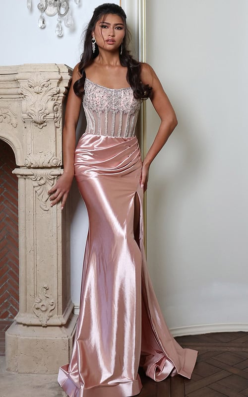 blush satin dress with beaded corset - front full body, resting hand on ornate fireplace