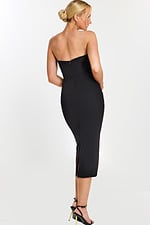 Back view of sleek black midi dress with slit and zipper closure