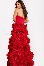 Red couture gown with large floral appliqués