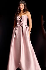 Glamorous strapless formal gown with oversized bow accents and voluminous silhouette