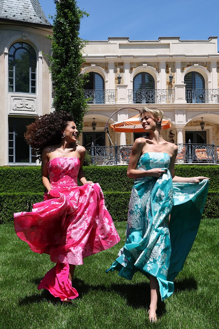 strapless jacquard gown with floral embroidery - two girls front, laughing, flowing skirts, barefoot