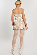 Detailed view of layered floral appliqués on ivory mesh dress