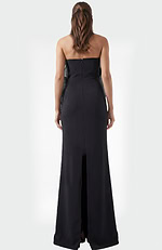 Back view of black strapless evening dress with smooth fitted silhouette and floor length hem
