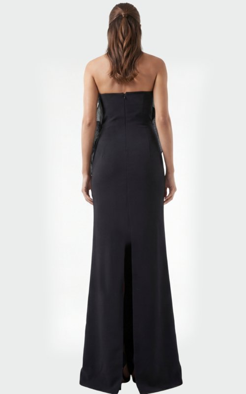 Back view of black strapless evening dress with smooth fitted silhouette and floor length hem
