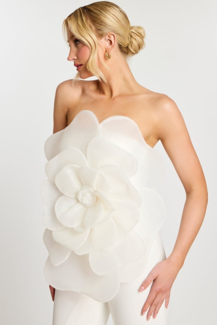 Side profile of model in off-white floral jumpsuit
