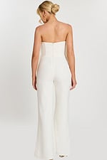 Back view of strapless off-white jumpsuit with zipper closure