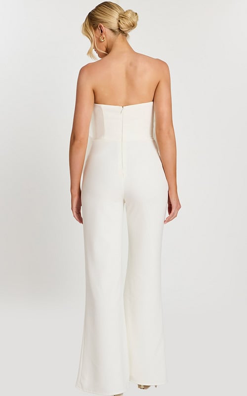 Back view of strapless off-white jumpsuit with zipper closure