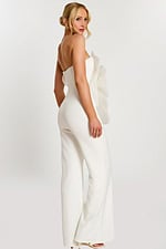 Over-the-shoulder pose showing back and side of white floral jumpsuit