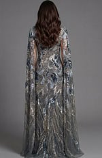 Back view of fitted sequin gown with flowing sheer cape detail