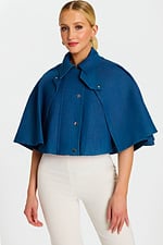 Model Wearing Cropped Denim Cape Jacket with Button Front and Wide Collar over White Pants
