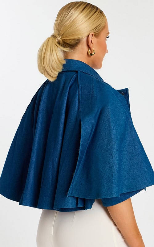 Back Angle View of Flared Denim Cape Jacket with Flowing Silhouette and Shoulder Seams