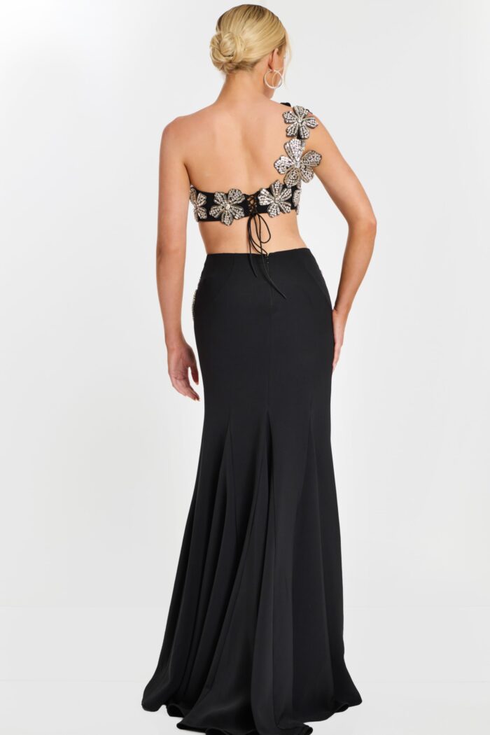 Back view of black skirt and floral lace-up crop top with flower appliqués