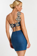 Back view of denim two-piece dress with lace-up closure and beaded flowers