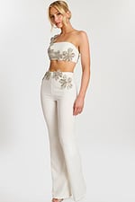 Model wearing ivory two-piece pantsuit with silver floral beading front view