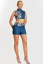 Angled view of embellished denim crop top and shorts