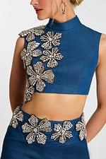Close-up of beaded floral crystal details on denim top and waistband