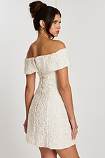 Side-back angle showing fitted waist and lace details on off-white dress