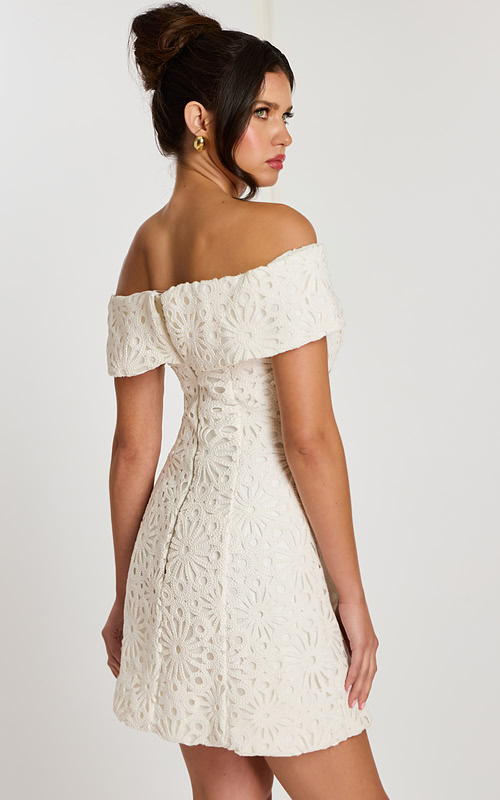 Side-back angle showing fitted waist and lace details on off-white dress