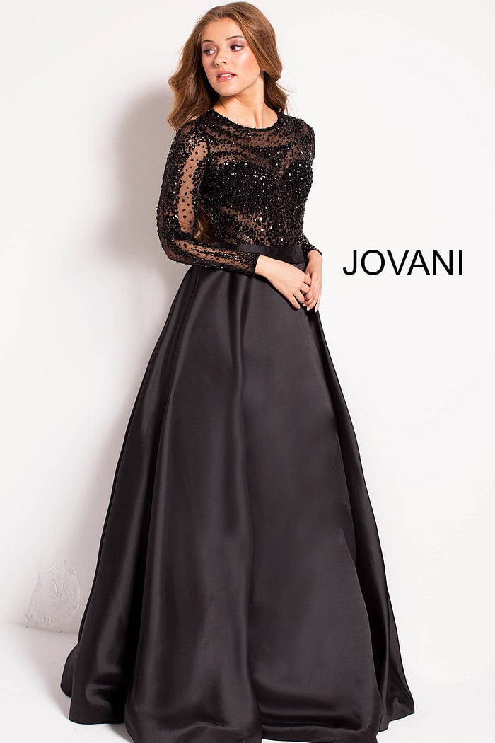 Model wearing Jovani 46066 black gown showing back detail and sheer sleeves