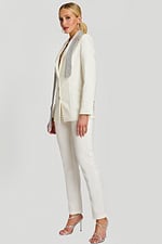 Side angle of white blazer pantsuit featuring shimmering lapel detail